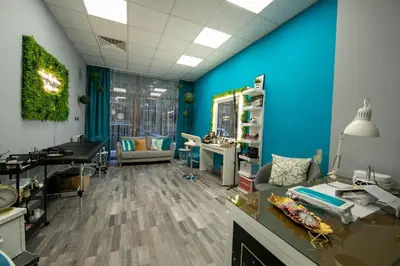 a room with a blue wall and a desk and a couch at Iceberg Studio 15 in Borovets