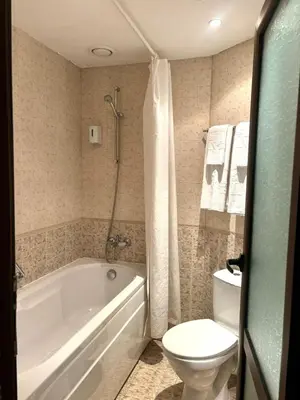 a bathroom with a white tub and a toilet at Еmerald Apartment Complex in Bansko