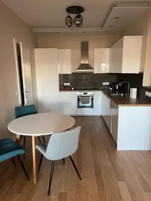 a kitchen with a table and two chairs and a table at Lux, Spacious and Comfort Apartment next to National Palace of Culture in Sofia