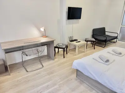 a room with a bed and a desk and chairs at Top Centre 2BDR Apartment for 4 Guests next to Theater Tear and Laughter in Sofia
