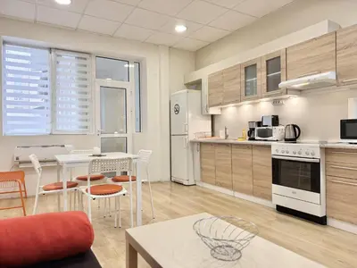 a large kitchen with a table and chairs in a room at Top Centre 2BDR Apartment for 4 Guests next to Theater Tear and Laughter in Sofia