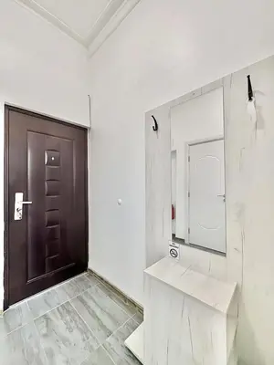 a bathroom with a wooden door and a mirror at Top City Centre 1BDR Apartment next to Theater Tear and Laughter in Sofia