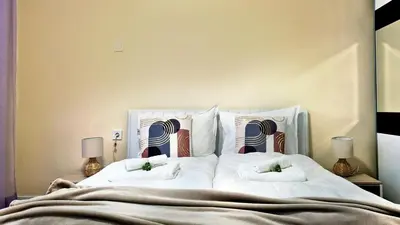 a bedroom with a large bed with two pillows at Spacious 3 BDR City Pulse near Airport, The Mall, Arena 8888 by KeyBox in Sofia