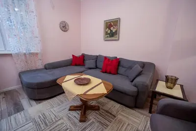 a living room with a blue couch and a table at Alex's Charming Apartment by NDK in Sofia
