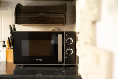 a microwave oven sitting on top of a counter at 1 min from NDK and Vitoshka street in Sofia
