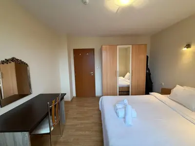 a hotel room with a bed with towels on it at Bansko Bliss - Peaceful Stay with Balcony Views in Bansko