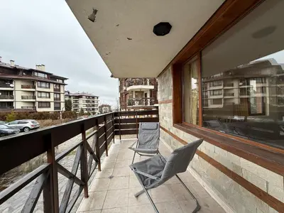 two chairs sitting on the balcony of a building at Bansko Bliss - Peaceful Stay with Balcony Views in Bansko