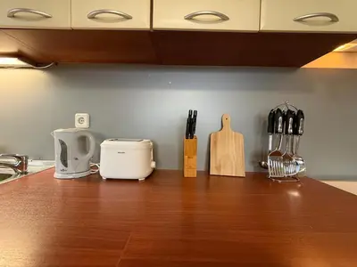 a kitchen counter with knives and a cutting board on it at Bansko Bliss - Peaceful Stay with Balcony Views in Bansko