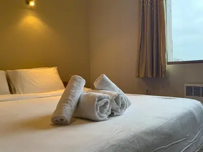 a room with a bed with towels on it at Bansko Bliss - Peaceful Stay with Balcony Views in Bansko