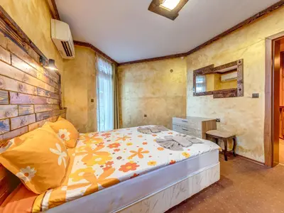 a bedroom with a bed in a room at Raikovski Livadi Mountain Villas Pamporovo in Smolyan