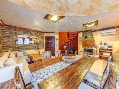 a living room with a wooden table and a couch at Raikovski Livadi Mountain Villas Pamporovo in Smolyan
