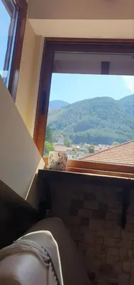 a large window with a view of a mountain at Къща за гости ОЗИ 3 in Ovchartsi