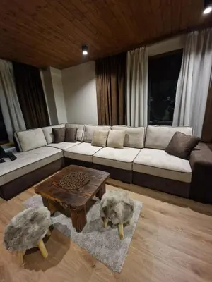 a living room with a couch and a coffee table at WoodLux in Pamporovo