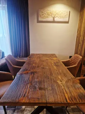 a large wooden table in a room with chairs at WoodLux in Pamporovo