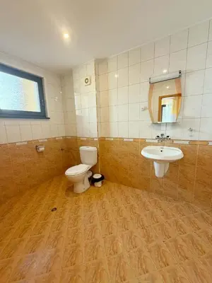 a bathroom with a toilet and a sink at Royal Apartment in Smolyan