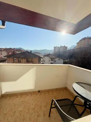 a balcony with a table and a chair on it at Royal Apartment in Smolyan