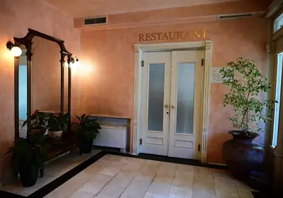 a entrance to a restaurant with a sign above the door at Family Hotel Lazur in Kyustendil