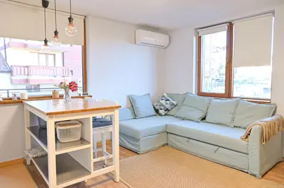 a living room with a couch and a table at Comfortable 1-Bedroom Apartments in Bansko - Close to Gondola by Flat Mаnаger in Bansko