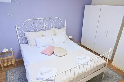 a bedroom with a white bed with white pillows at Comfortable 1-Bedroom Apartments in Bansko - Close to Gondola by Flat Mаnаger in Bansko