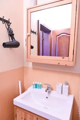 a bathroom with a white sink and a mirror at Comfortable 1-Bedroom Apartments in Bansko - Close to Gondola by Flat Mаnаger in Bansko