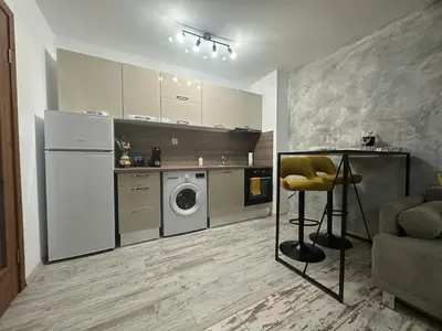 a kitchen with a refrigerator and a washing machine in it at Le Bijou МОЛ Плаза in Plovdiv