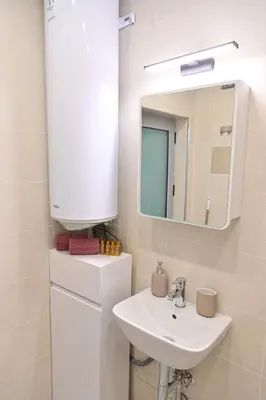 a bathroom with a sink and a mirror at White Peaks 1BR Apartment Bansko by SI Stay in Bansko