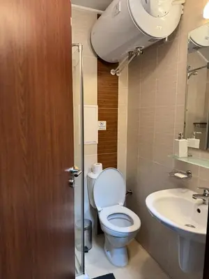 a bathroom with a toilet and a sink at Belmont Apartment in Bansko