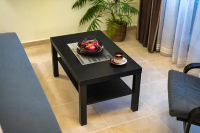 a black table with a basket of fruit on it at Апартамент Боров рай in Velingrad