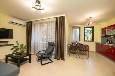 a living room with a table and a dining room at Апартамент Боров рай in Velingrad