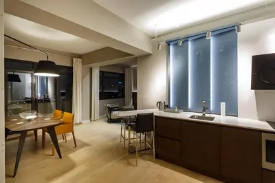 a kitchen and living room with a table and a kitchen and a dining room at NDK - Grand View Apartment in Sofia