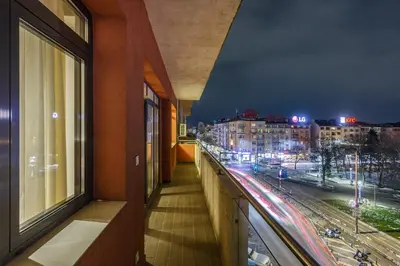a balcony with a view of a city at night at NDK - Grand View Apartment in Sofia