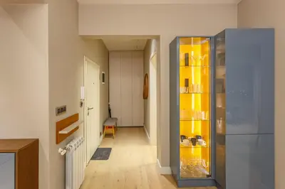a hallway with a large glass cabinet in a house at NDK - Grand View Apartment in Sofia