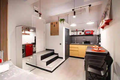 a small kitchen with a staircase in a room at Near NDK - Washer&Dryer - Fast Wi-Fi - Kitchenette in Sofia