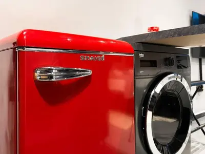 a red washing machine sitting next to a microwave at Near NDK - Washer&Dryer - Fast Wi-Fi - Kitchenette in Sofia