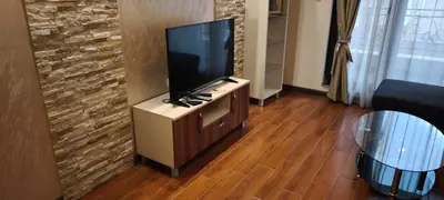 a living room with a flat screen tv on a cabinet at One Bedroom Apartment 4 - Restaurant Stadium Plovdiv in Plovdiv