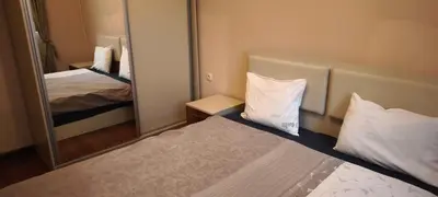 a small room with two beds and a mirror at One Bedroom Apartment 4 - Restaurant Stadium Plovdiv in Plovdiv