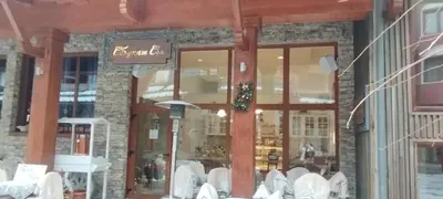 a restaurant with white chairs in front of a store at PIRIN GOLF - NIRVANA new, SPA in Razlog