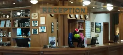 a bar in a restaurant with a sign that reads reception at PIRIN GOLF - NIRVANA new, SPA in Razlog