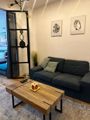 a living room with a couch and a coffee table at Serdika Central Stay - 2BD next to Serdika Metro Station in Sofia