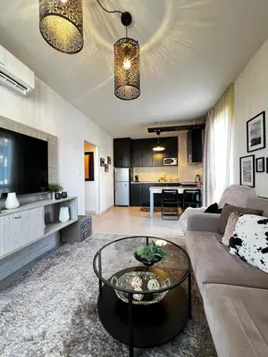 a living room with a couch and a table at BANSKO Deluxe Apartment Belvedere - 350m SkiLift in Bansko