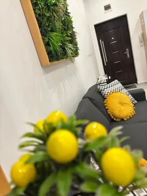 a living room with a couch with lemons on it at Luxury & Comfort near the University in Blagoevgrad