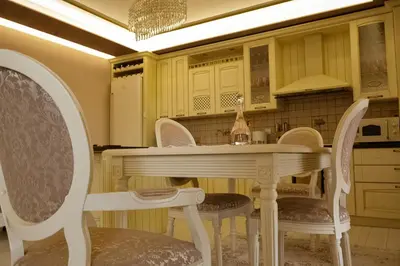 a kitchen with a white table and chairs at Апартамент за гости Марица in Asenovgrad