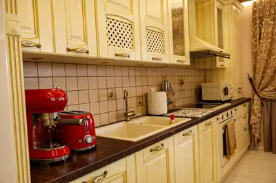 a kitchen with a sink and a red appliance at Апартамент за гости Марица in Asenovgrad
