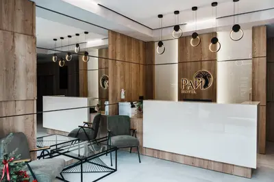 a lobby with a reception desk and chairs at Семеен хотел РАЙ in Ognyanovo