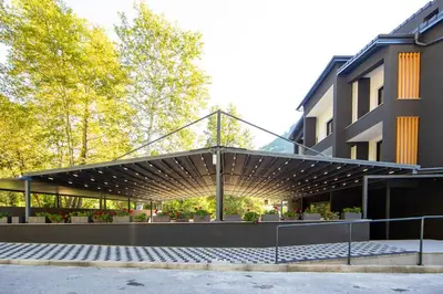 a building with awning in front of a building at Семеен хотел РАЙ in Ognyanovo
