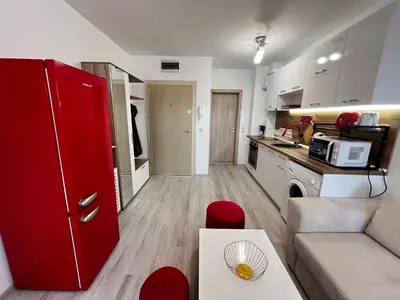 a kitchen and living room with a red refrigerator at Warsaw Cozy Studio near UNSS and NSA with Balcony in Sofia