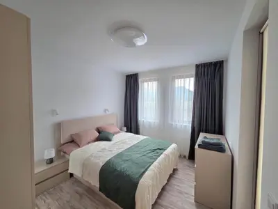 a bedroom with a bed and a window at Apartment Lily Complex Padaloto in Smolyan