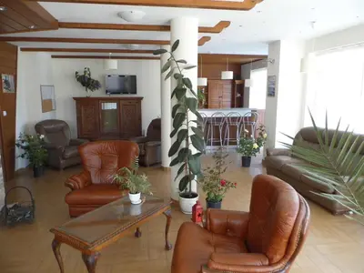 a living room with leather chairs and a table at Apartment at the foot of Pirin in Bansko