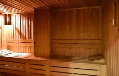 a wooden sauna with a bench in it at Apartment Danik City Garden in Bansko