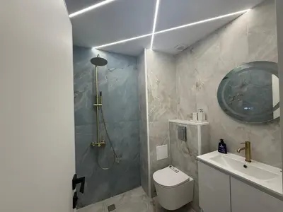 a bathroom with a shower and a toilet and a sink at River side apartment in Sandanski